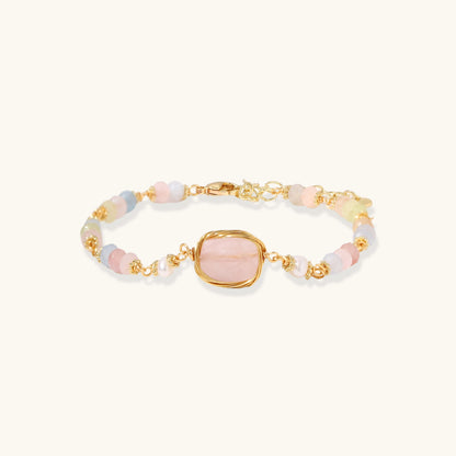 Delicate beaded bracelet with pastel rose quartz, pearls, and pink cushion-cut centerpiece in gold-plated setting